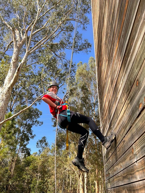 A scout abseiling down a wall